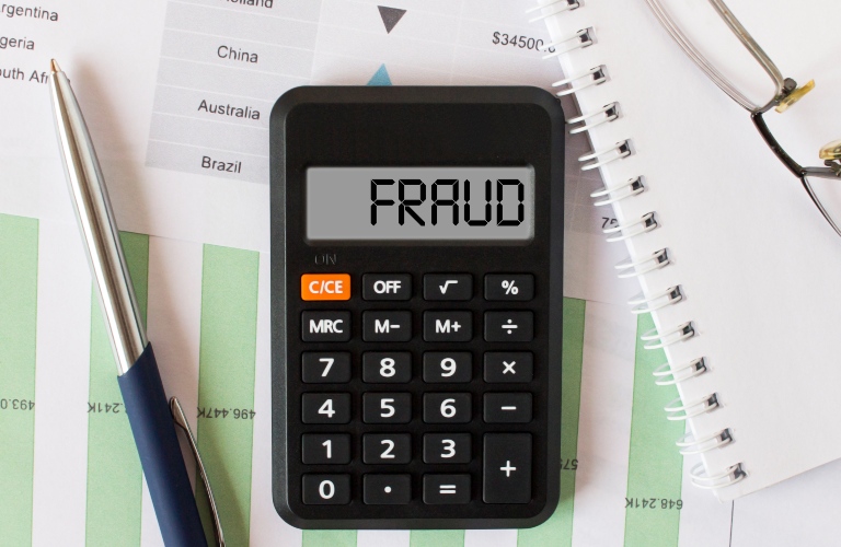 Calculator with the word Fraud on the display