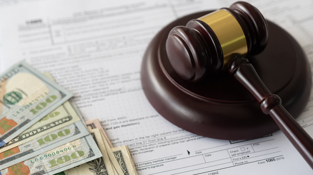judge gavel and money on income tax form