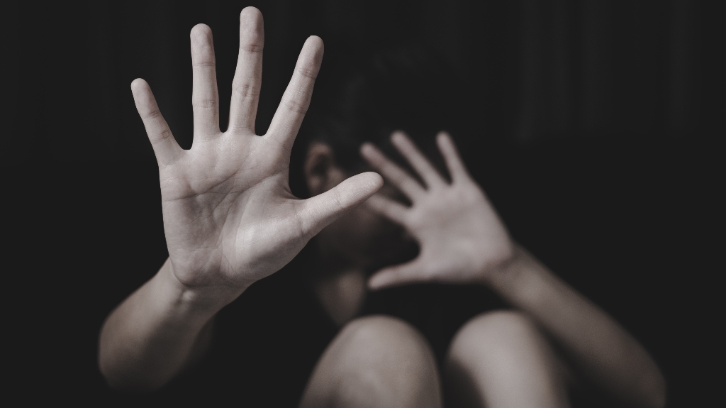 woman covers her face with her hands