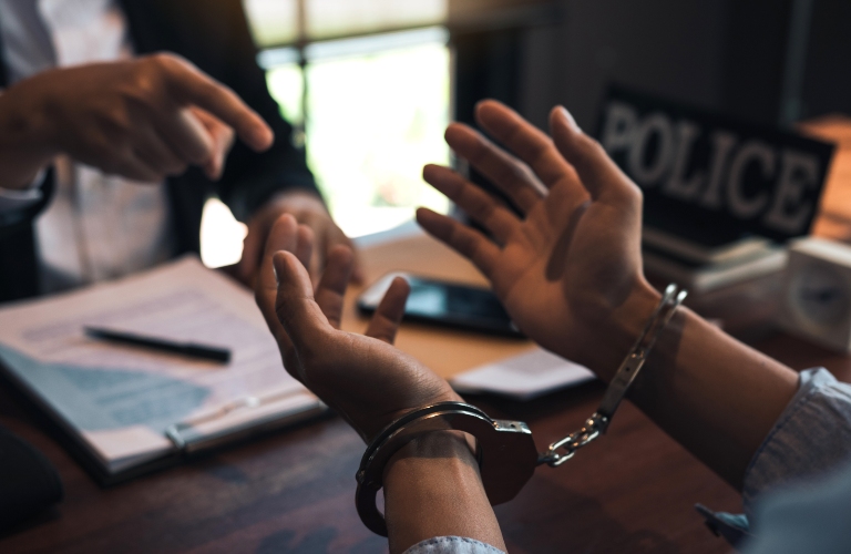 Police officers pointed to the handcuffs of offenders